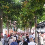 Lots of people on their way round the seating area to find their seats.