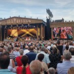 Orchestra passing through the crowd and up to the stage as they always do.