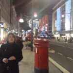 Astonished sister on Oxford Street with lights aglow